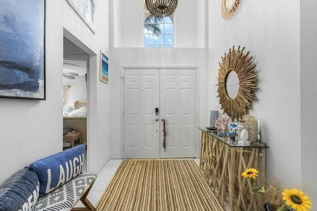 foyer entrance featuring a high ceiling and tile patterned floors