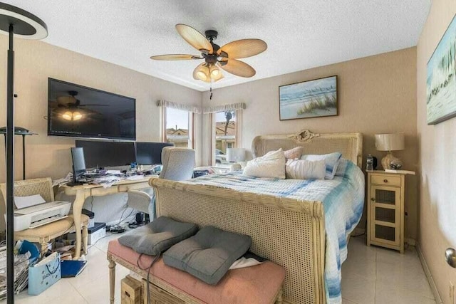 tiled bedroom with a ceiling fan and a textured ceiling