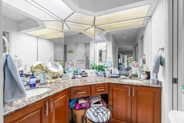 full bath featuring double vanity and a sink