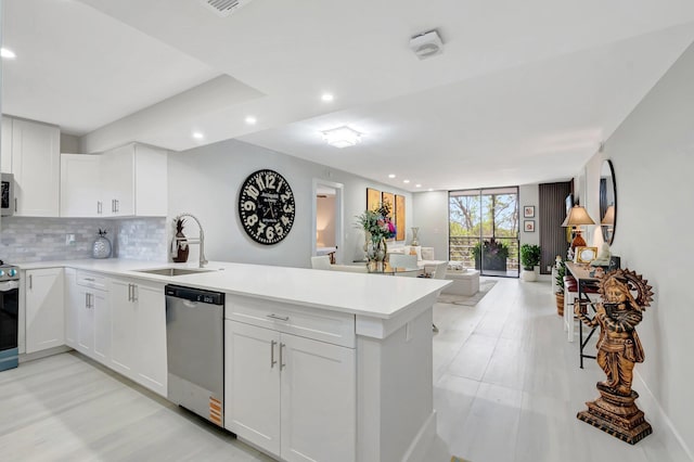 6461 NW 2nd Ave Unit 413, Boca Raton, FL 33487 - kitchen with appliances with stainless steel finishes, a peninsula, baseboards, white cabinetry, and recessed lighting