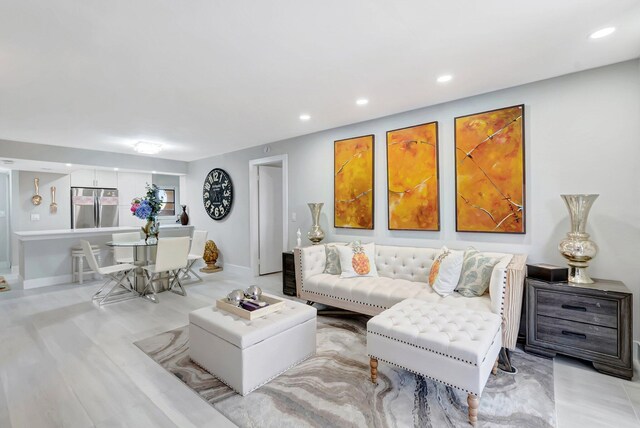 living room featuring recessed lighting and baseboards