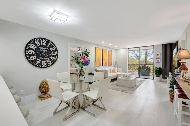 dining space featuring a wall of windows and recessed lighting
