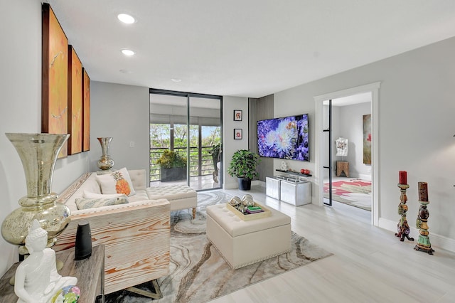 living room featuring recessed lighting and baseboards