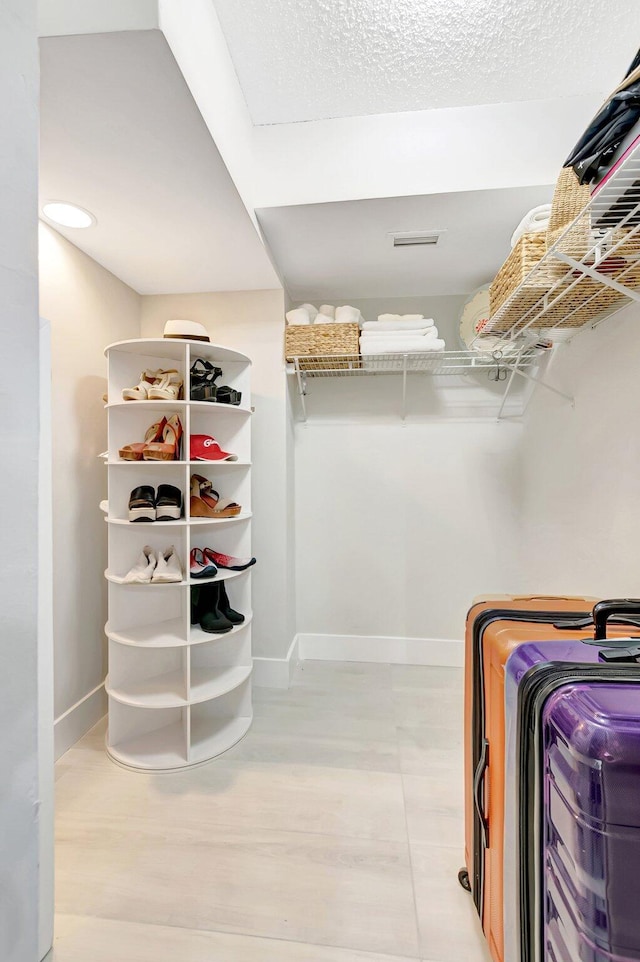 spacious closet featuring light wood-style flooring