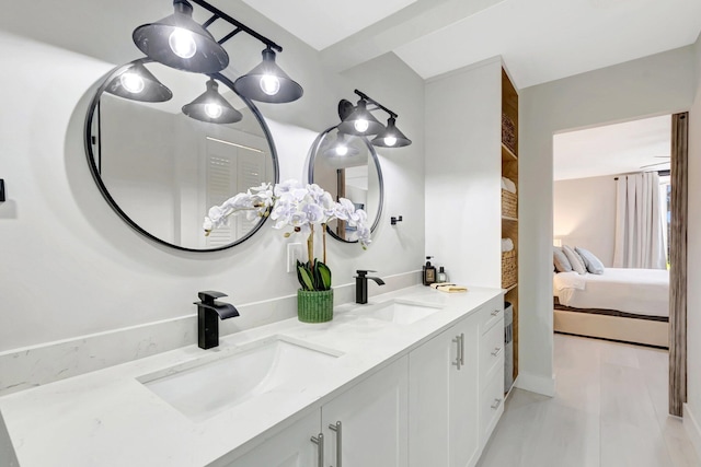 ensuite bathroom with a sink, double vanity, and ensuite bathroom