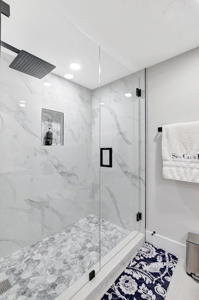 full bathroom featuring a marble finish shower and recessed lighting