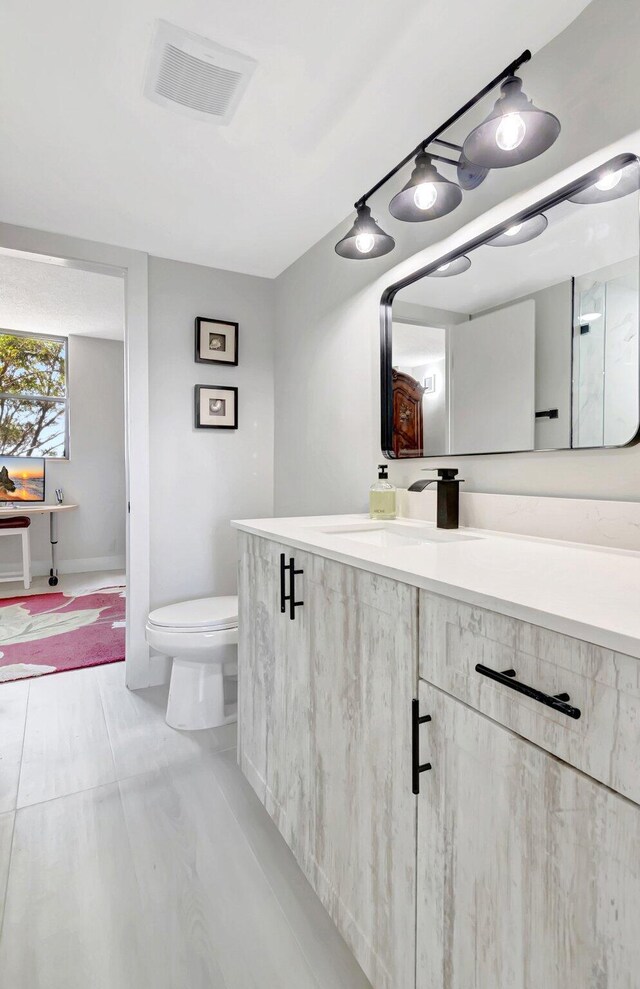 bathroom with a marble finish shower and visible vents