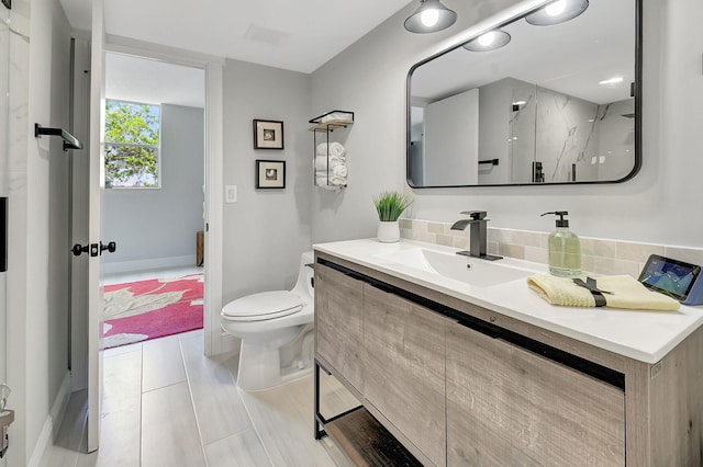 full bath featuring toilet, a marble finish shower, and vanity