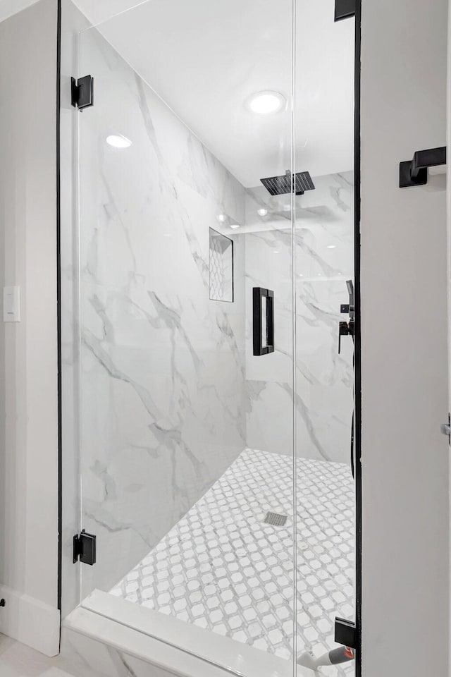 full bathroom featuring a marble finish shower and visible vents