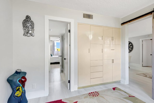 interior space with baseboards, visible vents, and wood finished floors