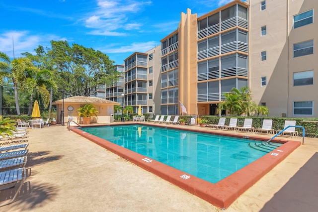 community pool featuring a patio area and fence