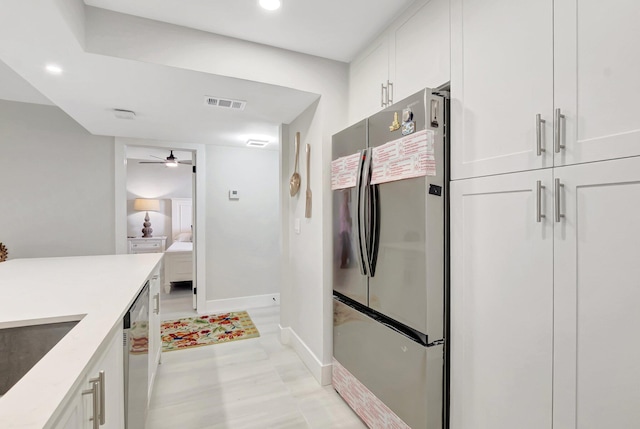 kitchen with stainless steel appliances, ceiling fan, visible vents, white cabinetry, and light countertops