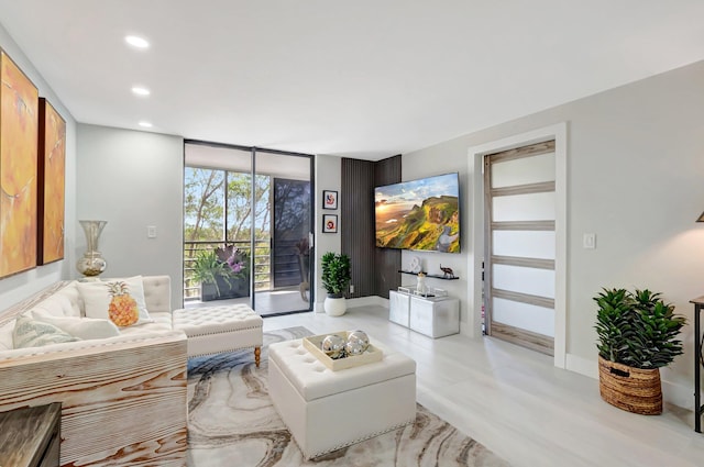 living room with a wall of windows, baseboards, and recessed lighting