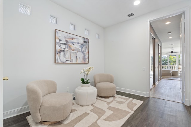 sitting room featuring dark wood-style floors, recessed lighting, visible vents, and baseboards