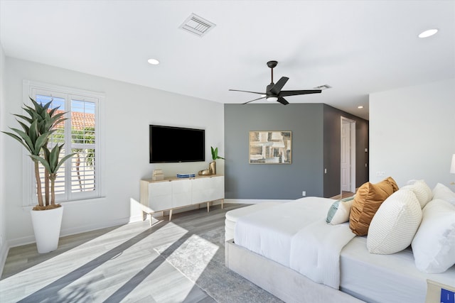 bedroom with recessed lighting, visible vents, a ceiling fan, wood finished floors, and baseboards