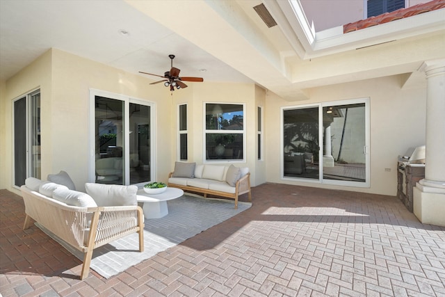 view of patio featuring ceiling fan, grilling area, and an outdoor living space