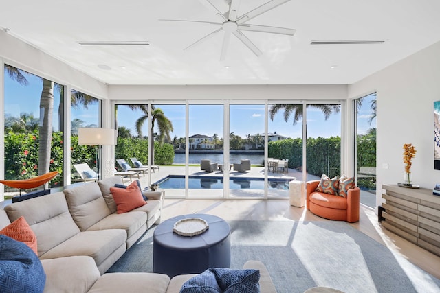 sunroom / solarium with visible vents, a healthy amount of sunlight, and a water view