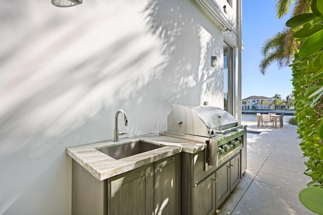 view of patio with a sink, a grill, and an outdoor kitchen