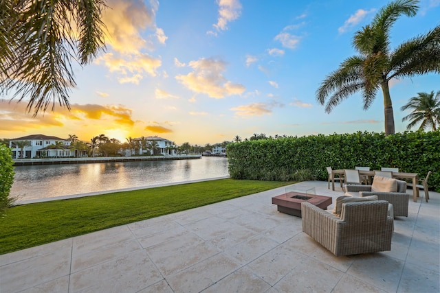 view of patio / terrace featuring a water view and a fire pit