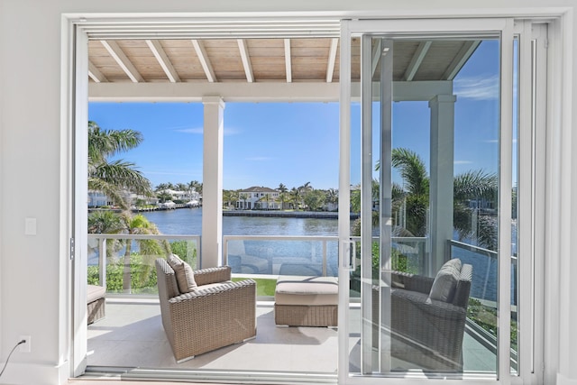 exterior space featuring a balcony and a water view