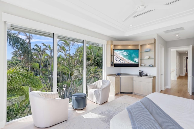 bedroom with visible vents, a tray ceiling, fridge, and light wood-style floors