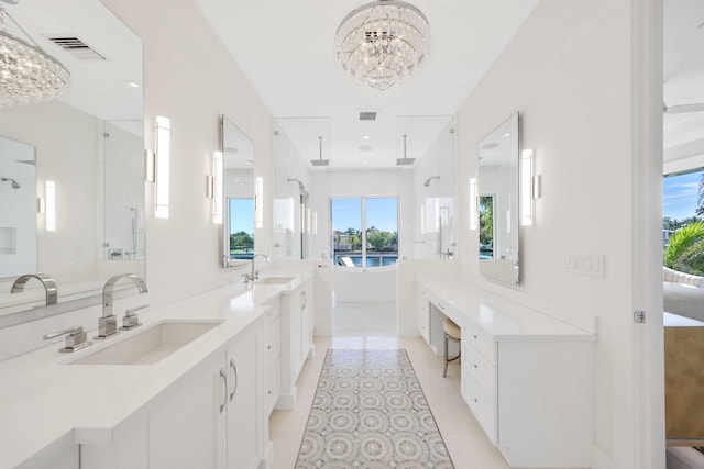 bathroom featuring a sink, a notable chandelier, a shower stall, and tile patterned floors