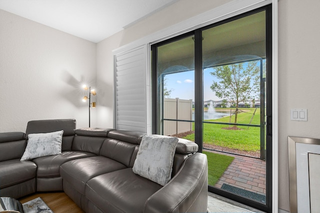 living room with a water view and light wood finished floors