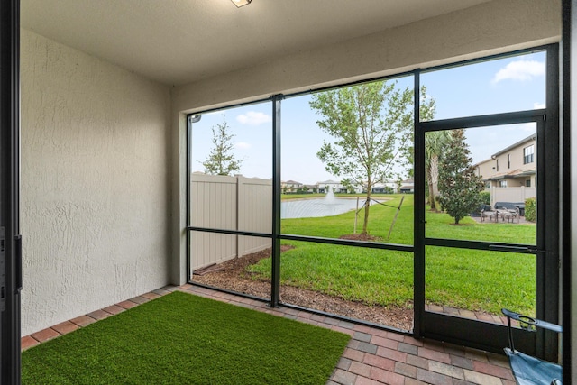 unfurnished sunroom with a healthy amount of sunlight and a water view