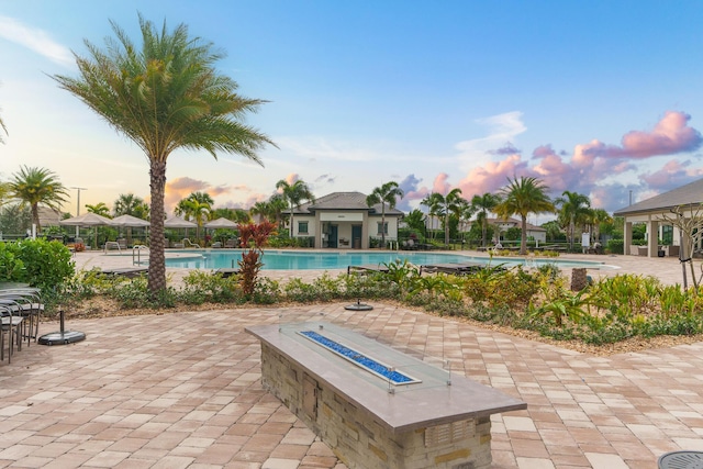 exterior space with an outdoor fire pit and a community pool