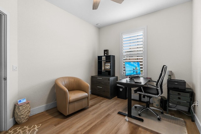 home office with ceiling fan, light wood-type flooring, and baseboards