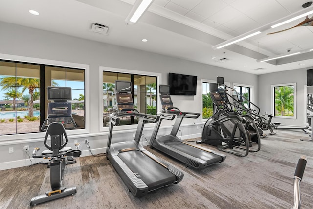 exercise room with visible vents, baseboards, wood finished floors, and recessed lighting