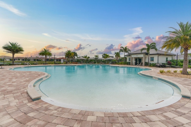 pool featuring a patio area and fence