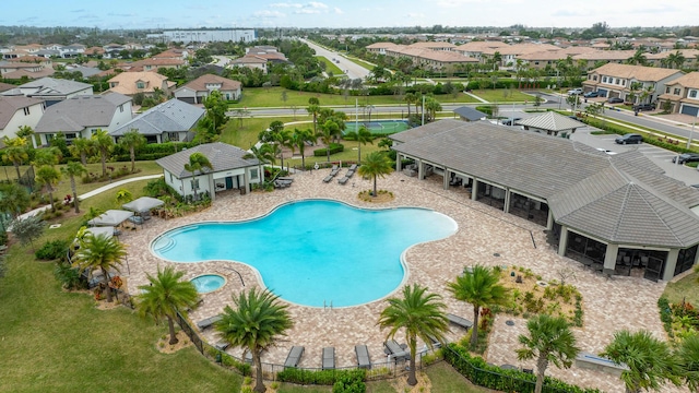 pool featuring a patio, fence, and a residential view