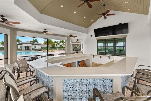 view of patio / terrace with a community pool, outdoor dry bar, and a ceiling fan