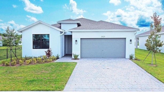 ranch-style home with an attached garage, fence, a front lawn, and stucco siding