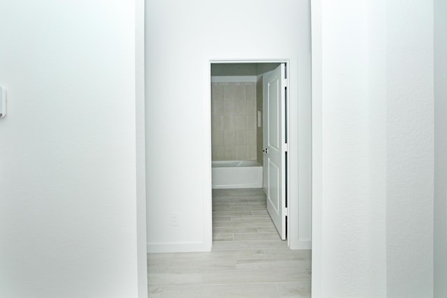 hallway featuring baseboards