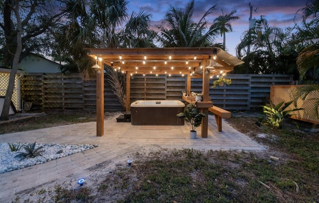 view of patio with a hot tub and a fenced backyard