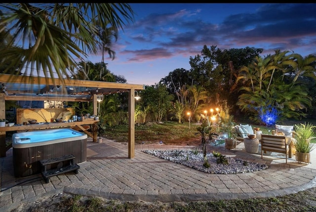 view of patio / terrace with a hot tub, outdoor lounge area, and a pergola