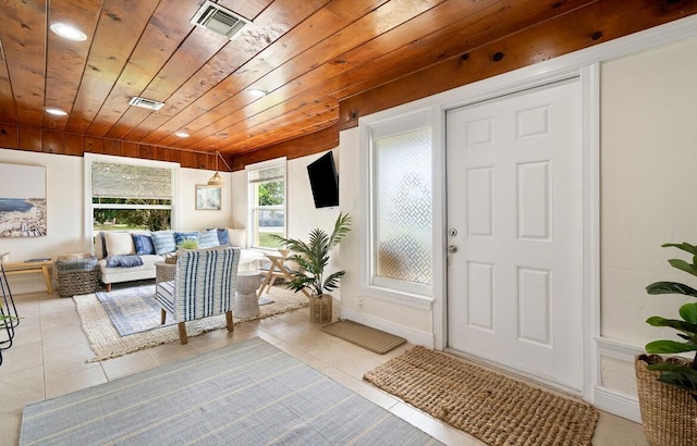 entrance foyer featuring light tile patterned floors, visible vents, and wood ceiling