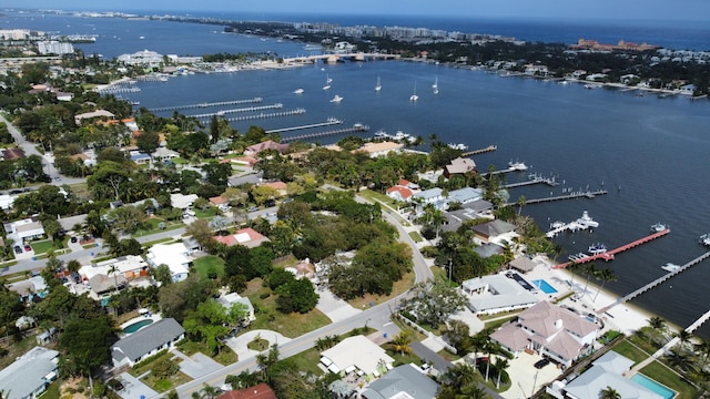 birds eye view of property with a water view and a residential view