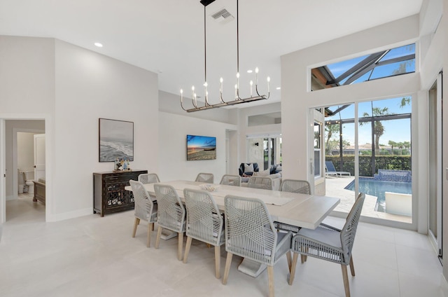 dining area featuring visible vents, baseboards, a high ceiling, a chandelier, and recessed lighting