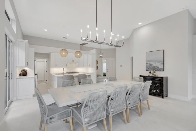 dining room featuring baseboards and recessed lighting