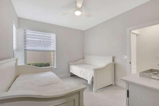 bedroom with ceiling fan and baseboards