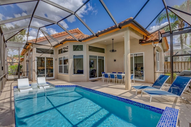 pool with a patio and glass enclosure