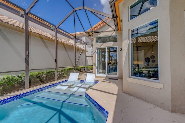 outdoor pool with a patio area and a lanai