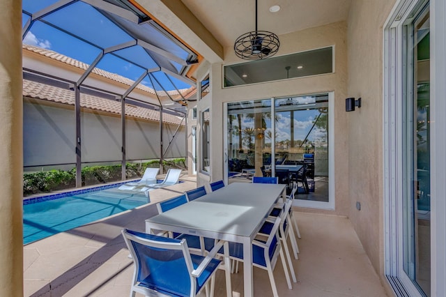 pool featuring outdoor dining area, a patio area, and a lanai