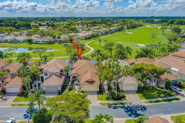 aerial view featuring view of golf course, a water view, and a residential view