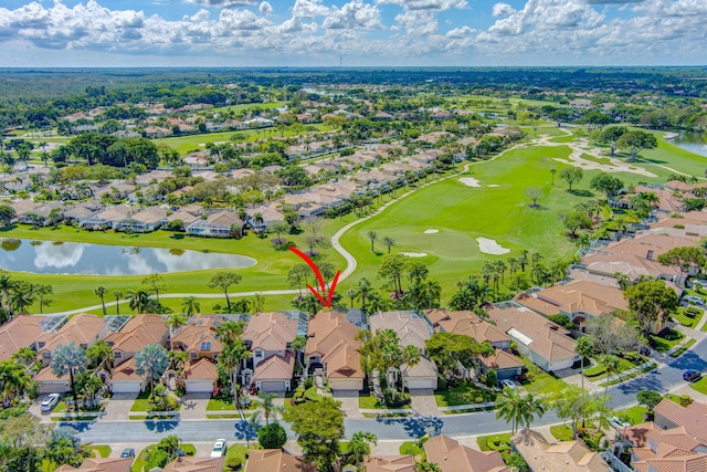 aerial view featuring view of golf course, a water view, and a residential view