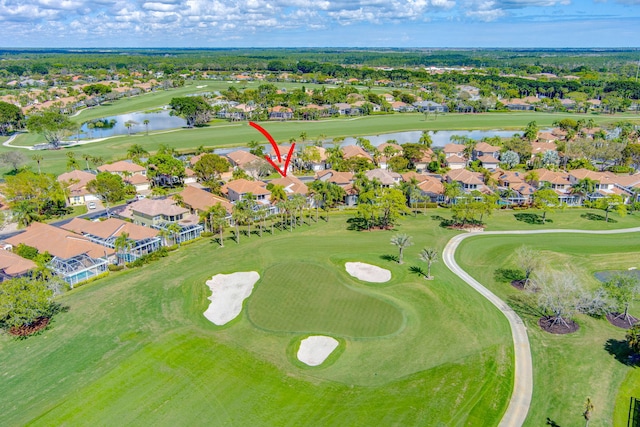 birds eye view of property with view of golf course, a water view, and a residential view