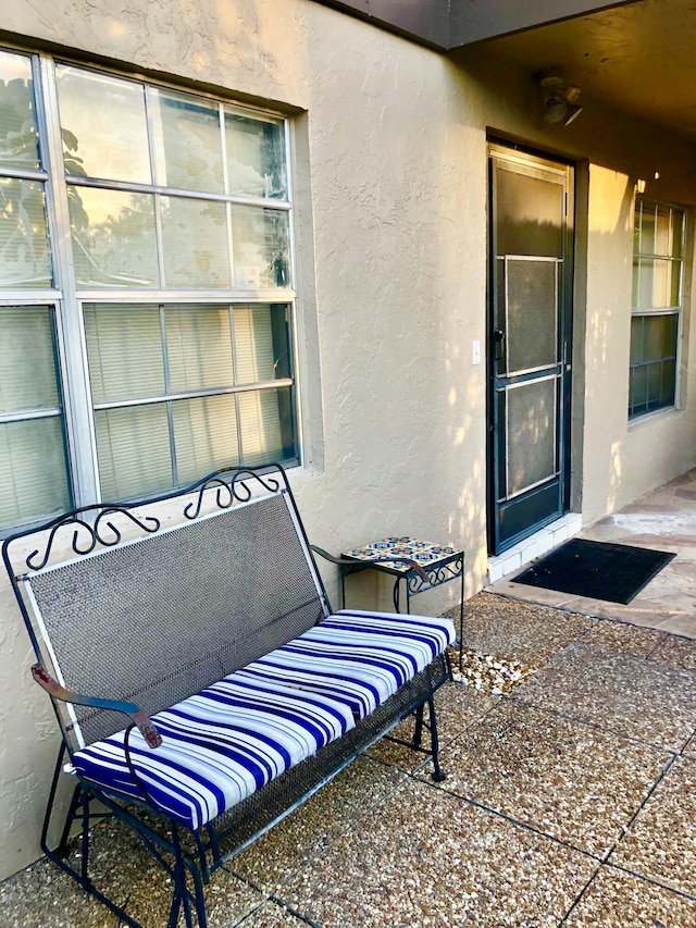 entrance to property with stucco siding